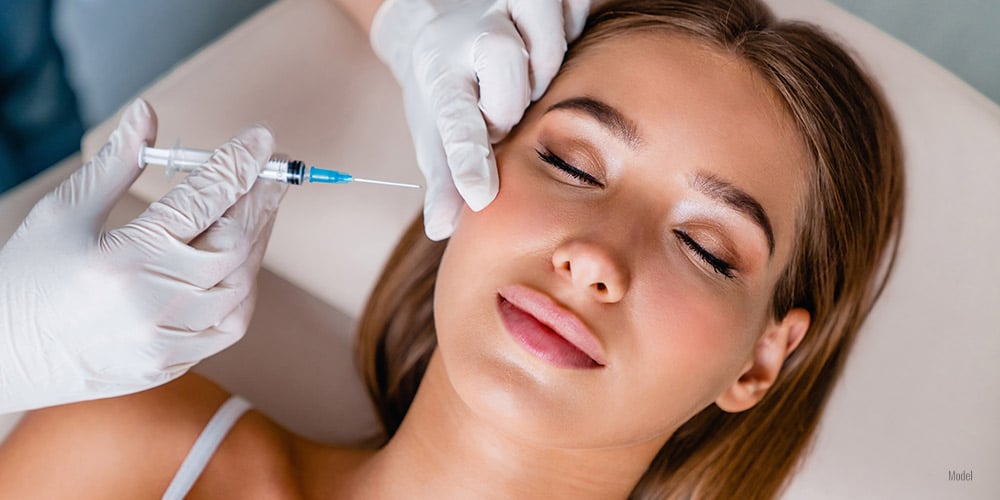 Young woman gets beauty facial injection