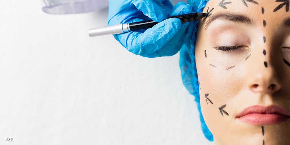 Patient with dotted lines on the face in an examination room.